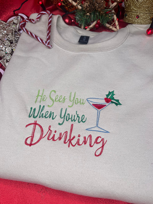 HE SEES YOU WHEN YOUR DRINKING EMBROIDERED SWEATSHIRT